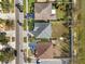 Aerial view of a well-maintained home with green lawn, complemented by adjacent properties and neighborhood streets at 707 Fern Leaf Dr, Ruskin, FL 33570
