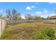 Large grassy backyard, ideal for to play, featuring a white fence for privacy at 707 Fern Leaf Dr, Ruskin, FL 33570