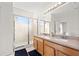 Bathroom featuring double sinks, a full mirror, and a glass-enclosed shower at 707 Fern Leaf Dr, Ruskin, FL 33570