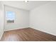 Bright bedroom features wood floors and a window for natural light at 707 Fern Leaf Dr, Ruskin, FL 33570