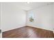Bright bedroom features wood floors and a window for natural light at 707 Fern Leaf Dr, Ruskin, FL 33570