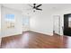 Spacious bedroom features wood floors, a ceiling fan, and two windows offering natural light at 707 Fern Leaf Dr, Ruskin, FL 33570