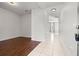 The spacious hallway combines laminate flooring with tile and is enhanced by natural light from the adjacent rooms at 707 Fern Leaf Dr, Ruskin, FL 33570