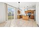 Modern kitchen featuring wood cabinets, granite countertops, stainless steel appliances, and access to the backyard at 707 Fern Leaf Dr, Ruskin, FL 33570