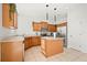 Bright kitchen with wood cabinets, granite countertops, stainless steel appliances, and a functional center island at 707 Fern Leaf Dr, Ruskin, FL 33570