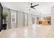 Expansive living area merges seamlessly with a kitchen featuring modern pendant lights, tile flooring, and stainless appliances at 707 Fern Leaf Dr, Ruskin, FL 33570