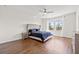 The well-lit primary bedroom offers wood floors and a large window for natural light at 707 Fern Leaf Dr, Ruskin, FL 33570