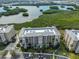 Aerial view of building and surrounding lake and foliage at 7194 Key Haven Rd # 405, Seminole, FL 33777