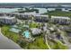 Gorgeous aerial view of condos, tennis courts, and swimming pool offering a luxurious living experience at 7194 Key Haven Rd # 405, Seminole, FL 33777