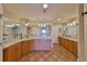 Large primary bathroom with double vanities, granite countertops, and tile flooring at 7194 Key Haven Rd # 405, Seminole, FL 33777