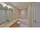 Bathroom with a granite countertop, a bath tub, and a vanity mirror at 7194 Key Haven Rd # 405, Seminole, FL 33777