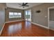 Bedroom featuring hardwood floors, a sliding glass door to balcony, and a ceiling fan at 7194 Key Haven Rd # 405, Seminole, FL 33777