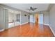 A lovely primary bedroom features wood floors, and sliding glass doors to outdoor lanai at 7194 Key Haven Rd # 405, Seminole, FL 33777
