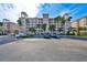 Exterior of the building with palm trees and beautiful sky at 7194 Key Haven Rd # 405, Seminole, FL 33777