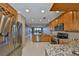 Well-lit kitchen with stainless steel appliances and granite countertops offering an open design to the living area at 7194 Key Haven Rd # 405, Seminole, FL 33777