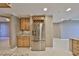 Modern kitchen area featuring stainless steel appliances including fridge, wine rack, and granite countertops at 7194 Key Haven Rd # 405, Seminole, FL 33777