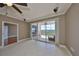 Bright living room with tile floors, ceiling fan, and sliding glass doors to the balcony at 7194 Key Haven Rd # 405, Seminole, FL 33777