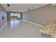 Bright and airy living room with tile floors, ceiling fan, and sliding glass doors to the balcony at 7194 Key Haven Rd # 405, Seminole, FL 33777