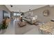 Bright and airy living room featuring neutral tones, stylish decor, comfortable seating, and access to a balcony at 7194 Key Haven Rd # 405, Seminole, FL 33777