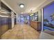 Nice interior lobby with two elevators, a tropical mural, and a wood console at 7194 Key Haven Rd # 405, Seminole, FL 33777