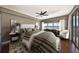 Comfortable main bedroom with a large bed, ceiling fan, and a window with natural light at 7194 Key Haven Rd # 405, Seminole, FL 33777