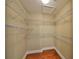 Spacious walk-in closet with custom shelving and wood flooring at 7194 Key Haven Rd # 405, Seminole, FL 33777