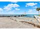 View of the pier and boat ramp with ocean views and blue skies, perfect for fishing and enjoying the water at 7414 S Kissimmee St, Tampa, FL 33616