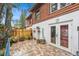 Charming backyard patio featuring stone paving, a white stucco wall, and lush plants at 799 Fairwood Ln, Clearwater, FL 33759