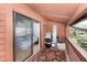 Balcony showing access to the bedroom, featuring wood paneling and an area rug at 799 Fairwood Ln, Clearwater, FL 33759
