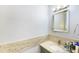 Bathroom vanity with a stylish marble countertop, modern fixtures and a sleek, frameless mirror at 799 Fairwood Ln, Clearwater, FL 33759