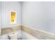 Powder room featuring elegant marble trim and a modern toilet, providing a comfortable and stylish space at 799 Fairwood Ln, Clearwater, FL 33759