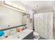 Bathroom featuring a blue vanity with a white countertop, a large mirror and a shower with curtain at 799 Fairwood Ln, Clearwater, FL 33759