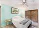 Bright bedroom with wood-look flooring, ceiling fan, and serene decor creates a tranquil and inviting space at 799 Fairwood Ln, Clearwater, FL 33759