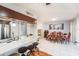 Bright dining area features a large table, seating for six, and direct access to the kitchen at 799 Fairwood Ln, Clearwater, FL 33759