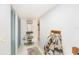 Clean hallway featuring white tile floors, blue closet doors, and a decorative rug at 799 Fairwood Ln, Clearwater, FL 33759