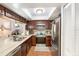 Bright kitchen featuring stainless steel appliances, wood cabinets, and a skylight for added natural light at 799 Fairwood Ln, Clearwater, FL 33759