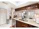 Kitchen island with a white countertop, stainless steel appliances, and dark wood cabinets at 799 Fairwood Ln, Clearwater, FL 33759