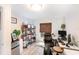 Bright home office with shelving, neutral walls, light floors, and a dark brown window shade at 799 Fairwood Ln, Clearwater, FL 33759