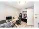 Well-lit home office featuring two white work desks and light wood flooring at 799 Fairwood Ln, Clearwater, FL 33759