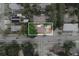A top-down aerial view of a home with a lush yard and tree coverage in a residential neighborhood at 8319 N 14Th St, Tampa, FL 33604