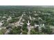 An aerial view of a cozy single-story home surrounded by lush greenery in a quiet residential neighborhood at 8319 N 14Th St, Tampa, FL 33604