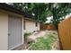 Backyard view shows yard, partial fence and structure of building with a door at 8319 N 14Th St, Tampa, FL 33604
