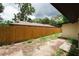 Backyard view shows long wooden fence and partial structure of building at 8319 N 14Th St, Tampa, FL 33604