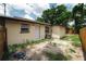 A view of the exterior of the house with the backyard with wooden fence at 8319 N 14Th St, Tampa, FL 33604