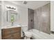Bathroom with a modern vanity, updated lighting, and tiled shower over tub at 8319 N 14Th St, Tampa, FL 33604