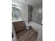 Updated bathroom with a modern vanity, new tile shower, and laminate flooring at 8319 N 14Th St, Tampa, FL 33604