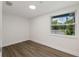 Bright, airy bedroom features wood-look floors and a large window at 8319 N 14Th St, Tampa, FL 33604