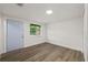 Bedroom with a new door, laminate flooring, and a large window at 8319 N 14Th St, Tampa, FL 33604