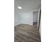 Bedroom with wood-look flooring and large closet for ample storage at 8319 N 14Th St, Tampa, FL 33604