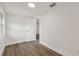 Spacious bedroom with new floors and an entry door in the hall at 8319 N 14Th St, Tampa, FL 33604
